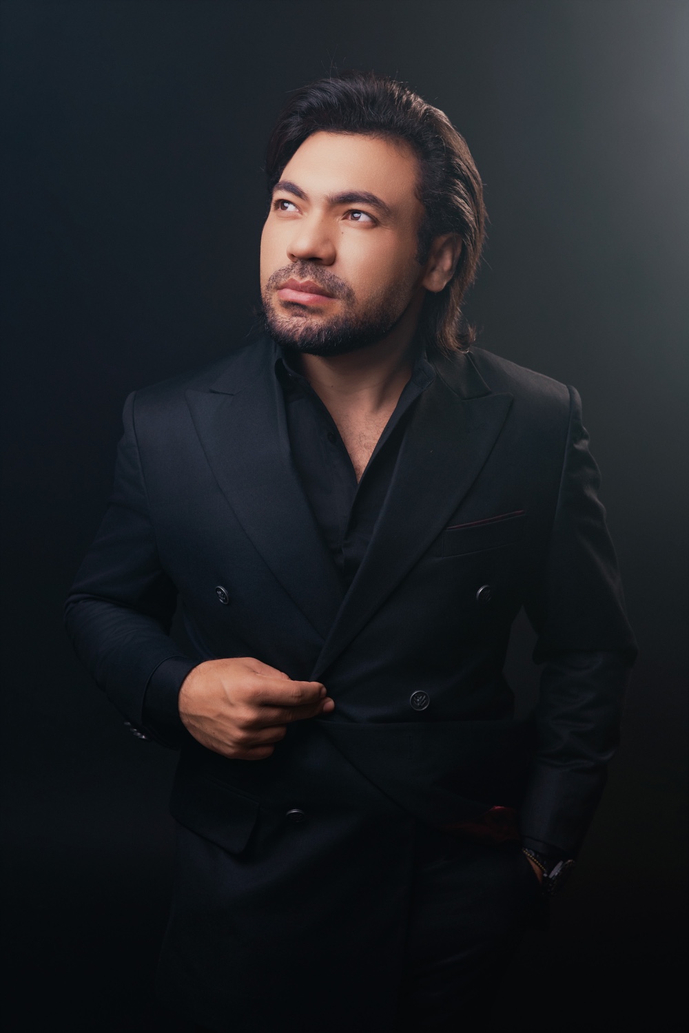 Renato Lourenzo de terno preto, com o olhar voltado à esquerda.
